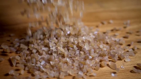Palm sugar falling onto kitchen table, slow motion Stock Footage 76386052