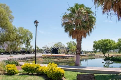 Palm tree and dome structure near pond at the malecon in Jamay, Jalisco, Mexico Stock Photos