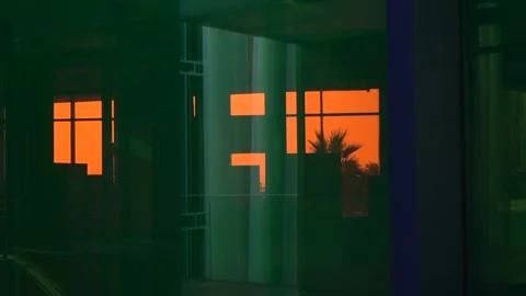 Palm tree in orange light reflecting in the window Stock Footage 144058153