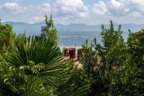 Palm trees and rooftops with Adriatic view and mountains in Lovran, Croatia 스톡 사진