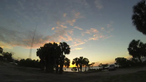 Palm trees and sunset over water Stock Footage 24975287