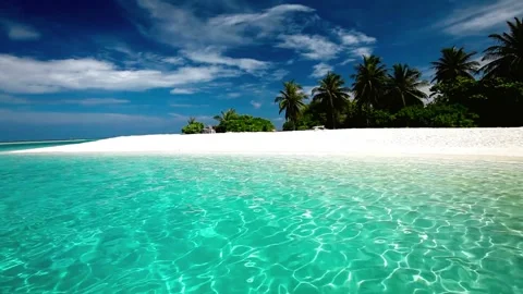 Palm trees over tropical lagoon with white beach Stock Footage 310482289