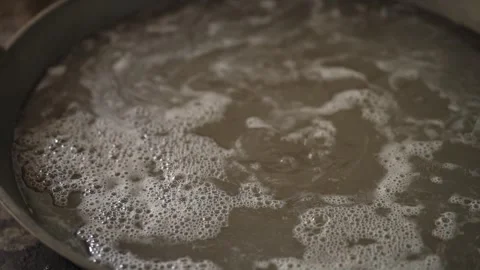 Palm water droplets fall on the heating pan in slow motion Stock Footage 261931008