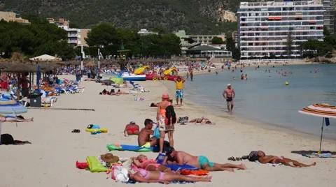 Palma Nova Mallorca Majorca: Tourists on beach and in sea Stock Footage 63163953