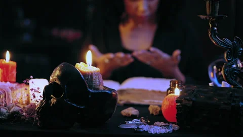 Palmist looking at hands after saying magic spell, mysterious atmosphere, ritual Stock Footage 201331424