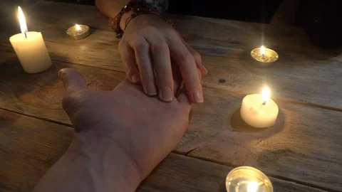 Palmistry concept. Fortune teller reading lines of good fortune on her hand, Stock Footage 121963444