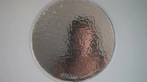 Palms of woman hands touching window and slides down glass. Concept of Stock Footage 229834423