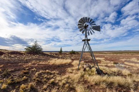 Pampa with old windmill on a farm in Bosques Petrificados de Jaramillo National Stock Photos