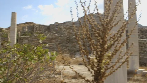 Pan of the 2,000 year old columns and ruins on the Greek island of Delos Stock Footage 108596447
