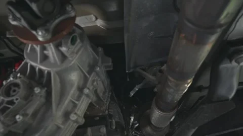 Pan from 4x4 transfer case to the exhaust on a diesel Mercedes sprinter van Stock Footage 245722585