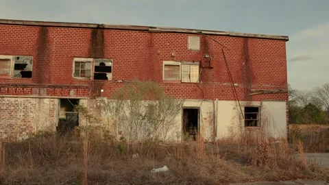 Pan of an abandoned old building in Georgia with busted windows and missing d Stock Footage 149454047