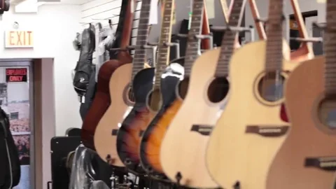 Pan acoustic guitars on wall Stock Footage 69111091