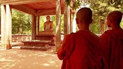 Pan across 2 monks viewing Buddha_ 0709 Stock Footage 41344880