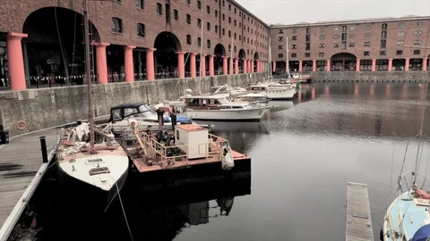 Pan across Albert Dock with moored yachts and boats in Liverpool, UK Stock Footage 99736146