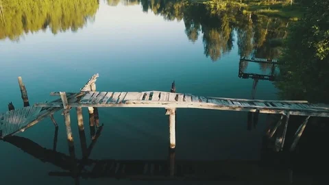 Pan across the broken bridge over the lake Video stock 77735183