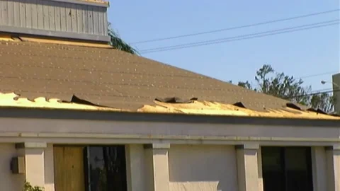Pan Across Burger King Rooftop Tiles Missing after Hurricane Wilma Stock Footage 291000462