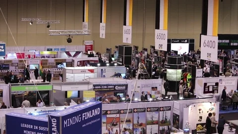 Pan across a busy convention of mining and industry Stock-Footage 73754217