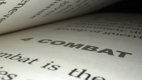 Pan Across Chapter Titled "Combat" in Book Stock Footage 130146544