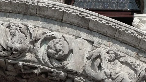 Pan across close up of the medieval sculpture of Christ around the architrave Stock Footage 83382186