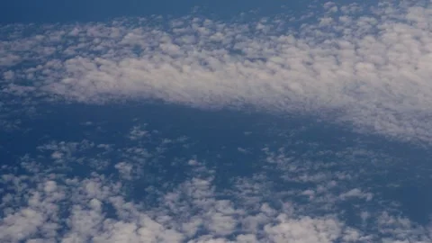 Pan Up Across Clouds with Sea Far Below Stock Footage 345437017