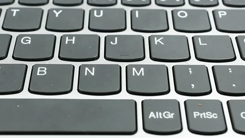 Pan Across Computer Keyboard on Black Background Stock Footage 336610441
