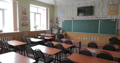 Pan across empty classroom in school - chairs and desks without anyone sitting Stock Footage 222961843