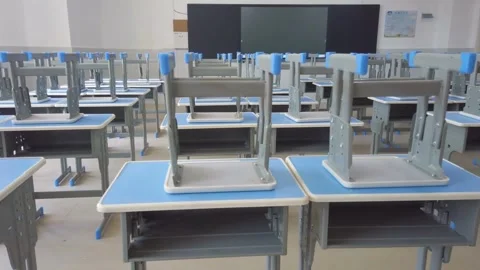 Pan across empty classroom in school or university chairs and desks without Stock Footage 256720882