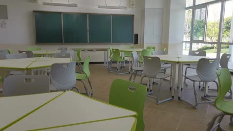 Pan across empty classroom in school or university chairs and desks without Stock Footage 256720967