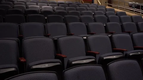 A pan across empty seats in a school auditorium Stock Footage 318473500