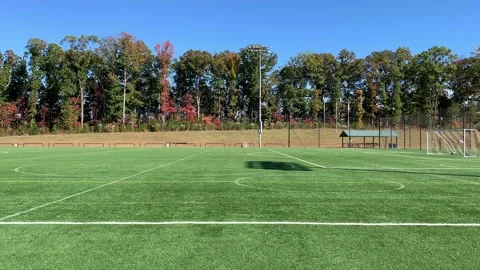 Pan across an empty soccer field on a Carolina blue sky day in autumn Stock Footage 165417283