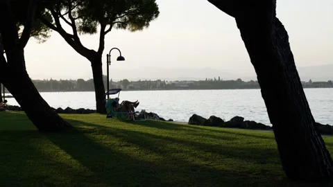 A pan across an evening beach scene in Italy Stock Footage 239094616