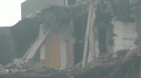 Pan across the exposed 7th floor of old tower block during demolition Stock Footage 14772435