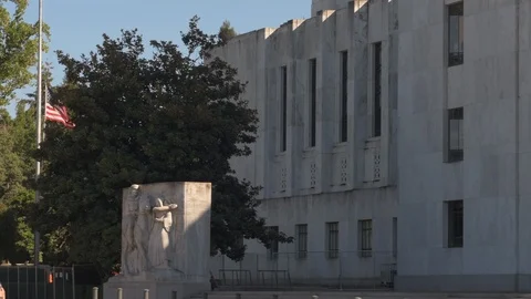 Pan across front of Oregon Capitol building, resting on titleing above entrance. Stock Footage 94587989