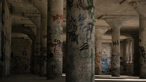 Pan across graffiti pillars shaky handheld Stock Footage 89985783