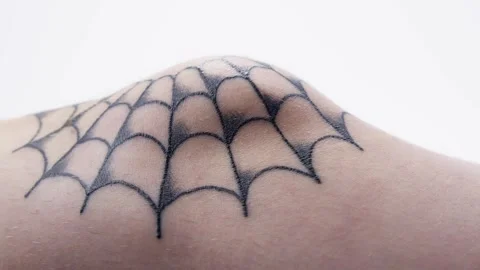 Pan Across a Healing Spider Web Tattoo Design on a Male Knee Stock Footage 276274332
