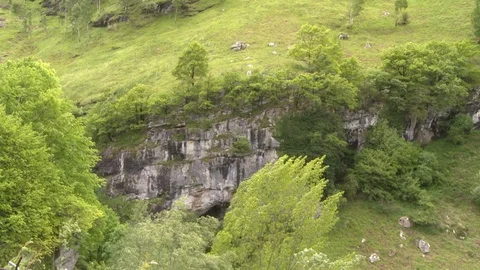 Pan across hillside with rocky cliffs in Lourdes, France Stock Footage 86758628