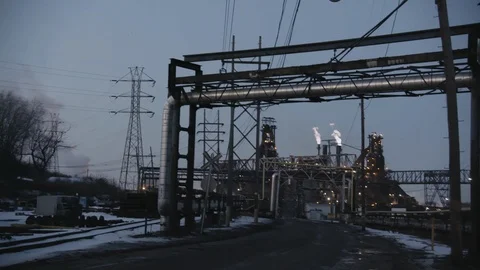 Pan across industrial landscape with train tracks and smoke stacks Stock Footage 89945328