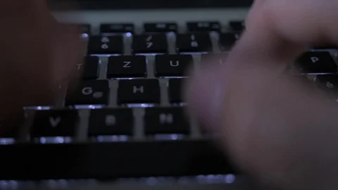 Pan across keyboard while typing Stock Footage 122128020