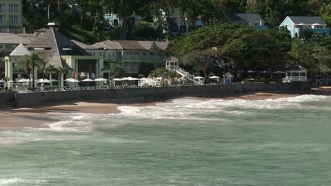 Pan across La Toc beach as waves crash ashore in St Lucia Stock Footage 75218290