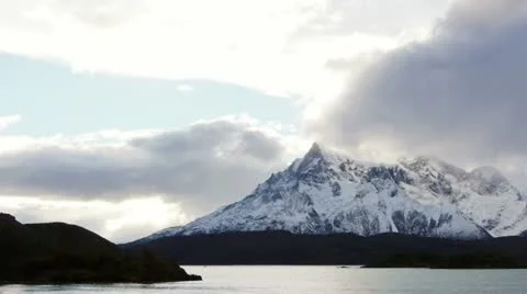 Pan across lake at base of mountains in Torres del Paine national park Stock Footage 12476771