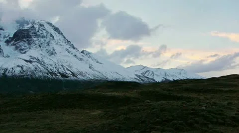 Pan across lake at base of mountains during sunset in Torres del Paine Stock Footage 12477266