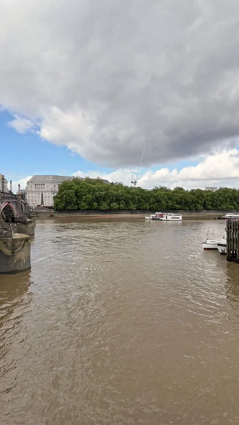 Pan across Lambeth Bridge and the River Thames in the city of London Stock Footage 283296063