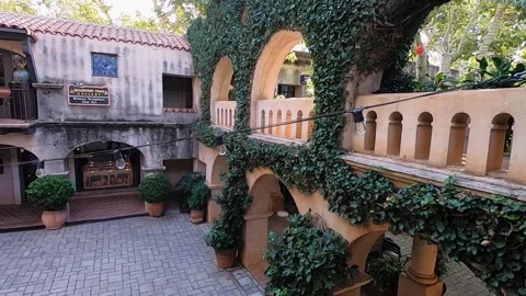 Pan across a light string over the ivy-covered arches and one of the many Stock Footage 144374038