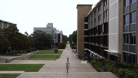 Pan across the lower campus buildings and environment of UNSW, Australia Stock Footage 220127232