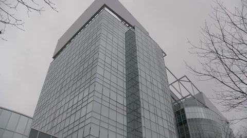 Pan across mirrored office building in fog winter Stock Footage 89945527
