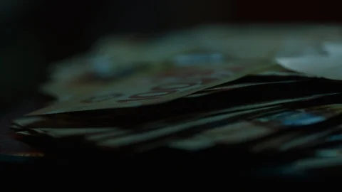 Pan across money lying on table very close Canadian currency 스톡 동영상 104607132