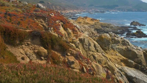 Pan Across the multicolored cliffs and outcroppings at Big Sur, above the Ocean Stock Footage 93665050