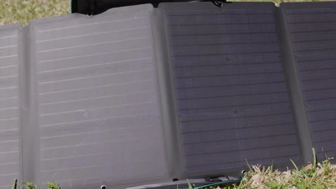 Pan across a portable solar panel setup in the sun 스톡 동영상 172806048