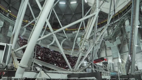 Pan across primary mirror array inside large optical telescope building Stock Footage 254769952