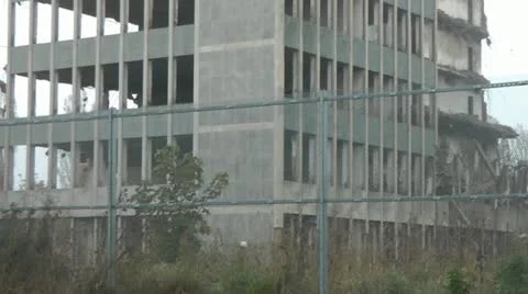 Pan across remains of old tower block during demolition Stock Footage 14776926